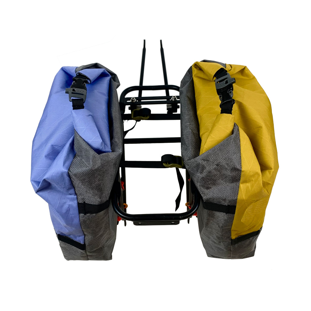 MLD Poco Paniers V3 on a bike rake. There is a Bluebell blue panier on the left and a Goldenrod yellow panier on the right.